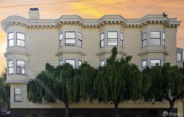 a view of a big building with a clock tower in middle