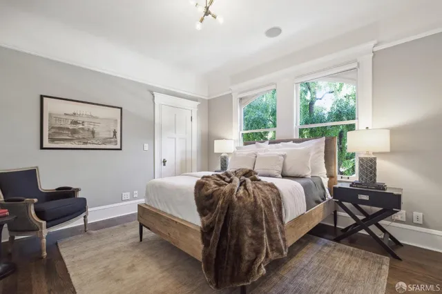 a bed room with a bed and a chair