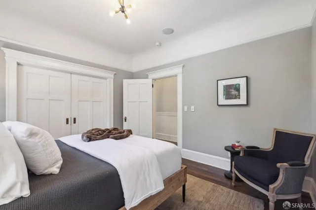 a bedroom with a bed and chair