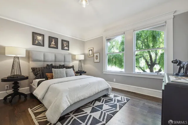 a bedroom with a bed and a large window