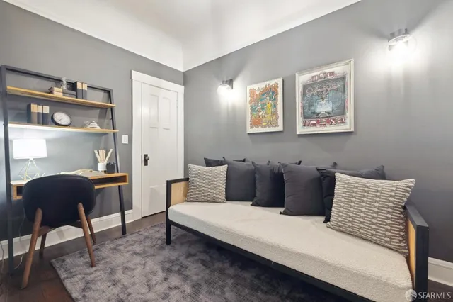 a living room with furniture and a lamp