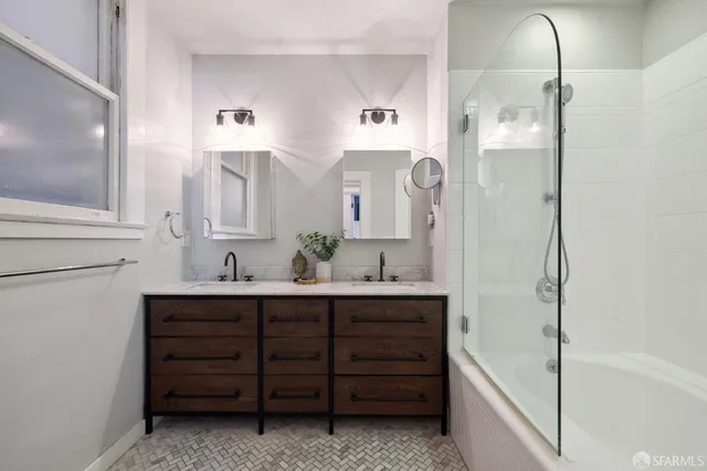 a spacious bathroom with a bathtub sink and mirror