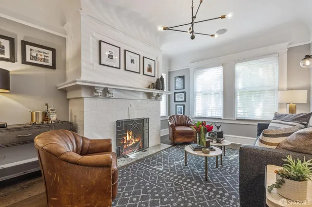 a living room with furniture fireplace and window