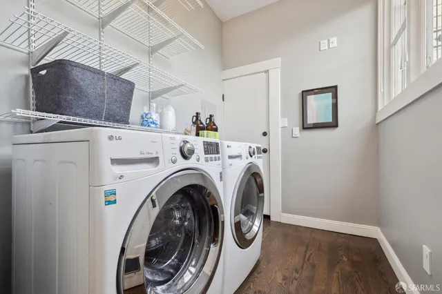 a view of washer and dryer with kitchen in the background
