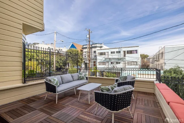 a balcony with furniture and a potted plant