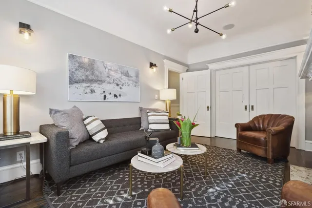 a living room with furniture and a potted plant