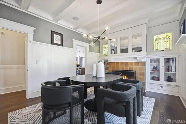 a dining room with furniture a chandelier and wooden floor