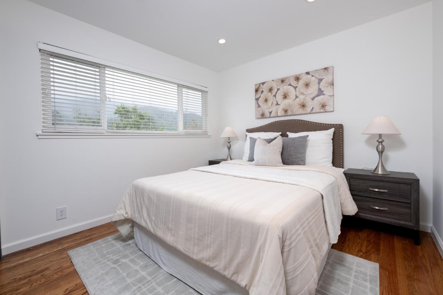 3 Yellowstone Way Pacifica, CA 94044 - Photo 13 of 18 a bedroom with a bed and a painting on the wall