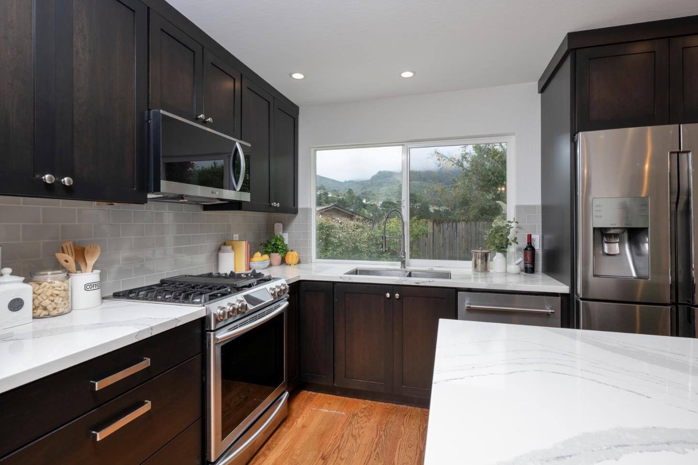 3 Yellowstone Way Pacifica, CA 94044 - Photo 6 of 18 a kitchen with stainless steel appliances granite countertop a stove a sink dishwasher a refrigerator and a microwave oven with cabinets