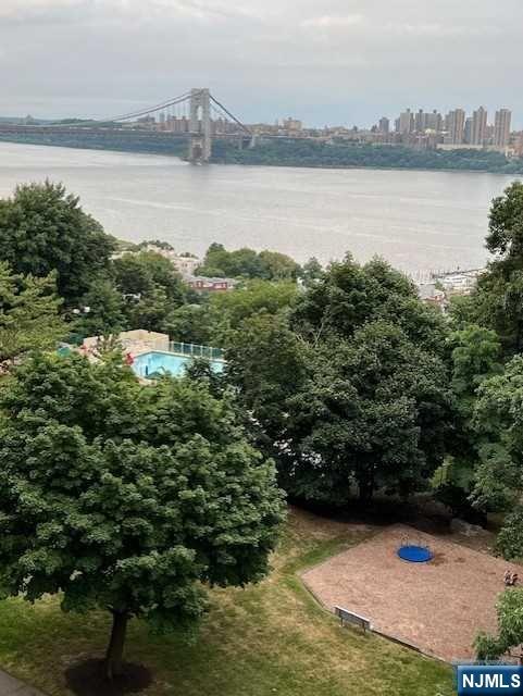 2 Horizon Road, Unit 1423 Fort Lee, NJ 07024 - Photo 24 of 30 a view of a lake with houses in the back