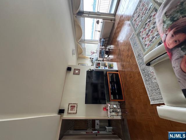 2 Horizon Road, Unit 1423 Fort Lee, NJ 07024 - Photo 4 of 30 a living room with furniture and a flat screen tv