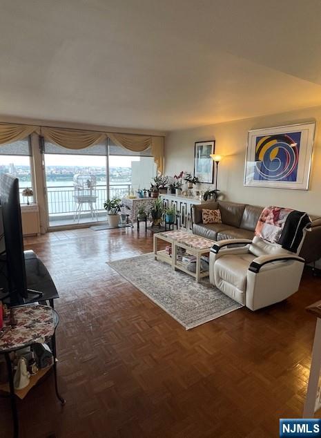 2 Horizon Road, Unit 1423 Fort Lee, NJ 07024 - Photo 5 of 30 a living room with furniture and a flat screen tv