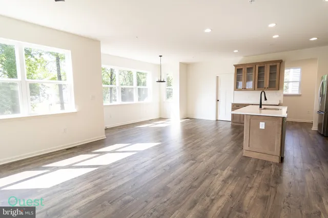 a kitchen with stainless steel appliances a stove top oven and white cabinets