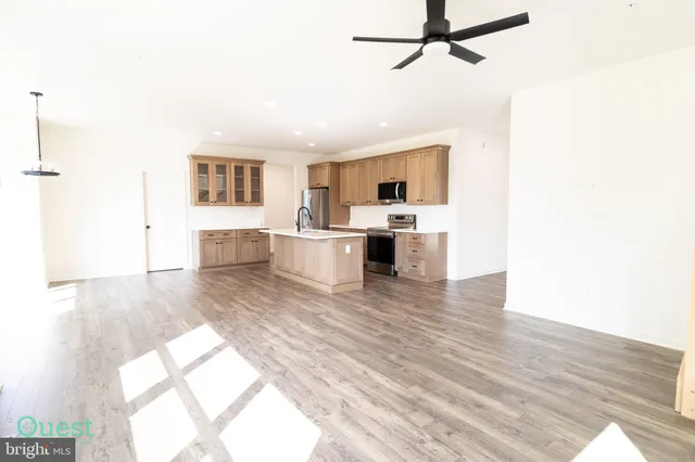 a kitchen with stainless steel appliances a refrigerator and a microwave