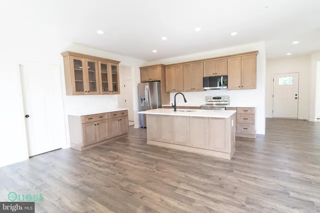 a kitchen with a sink appliances and cabinets