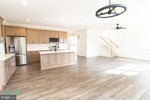 a kitchen with stainless steel appliances a white stove top oven and a refrigerator