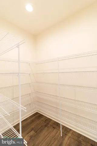 a view of cabinets a wooden floor and a sink