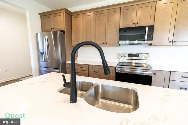a kitchen with a stove microwave and sink