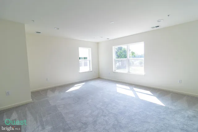 a white toilet sitting next to a white wall