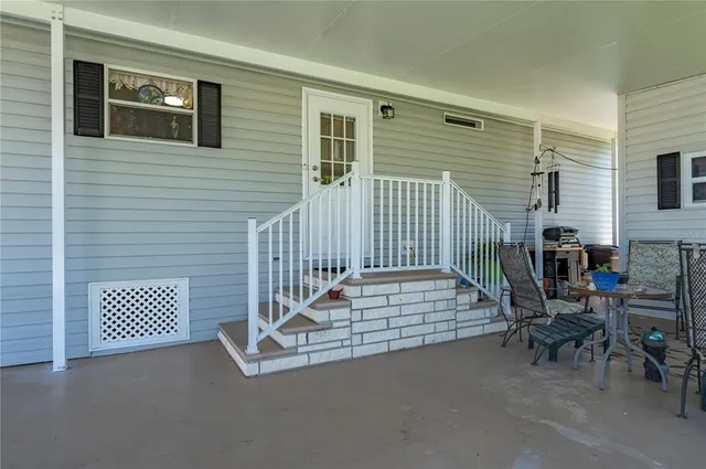 a view of a chairs and table in patio