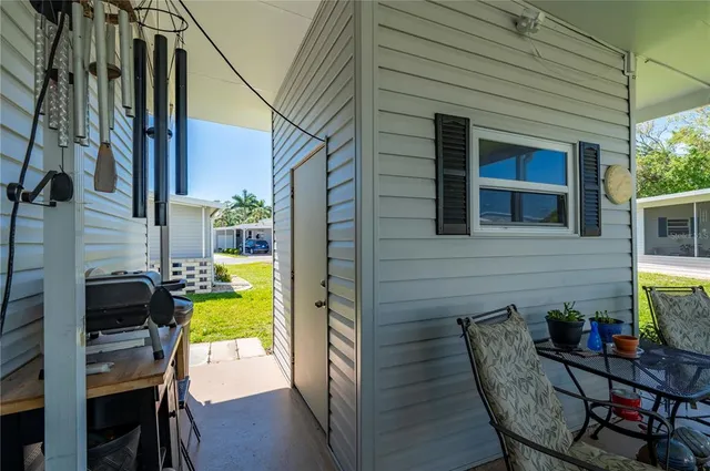 a front view of house with yard and trees in the background