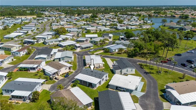 a aerial view of a house with a yard table and chairs