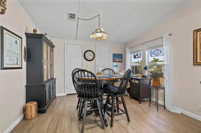 a dining room with furniture a rug and a chandelier