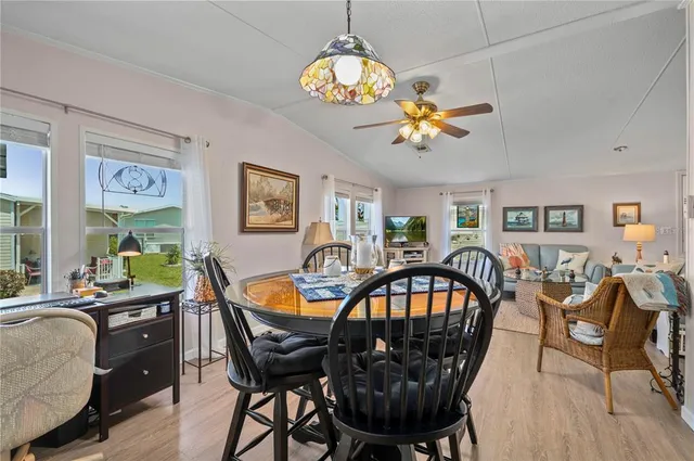 a kitchen with cabinets stainless steel appliances and wooden floor