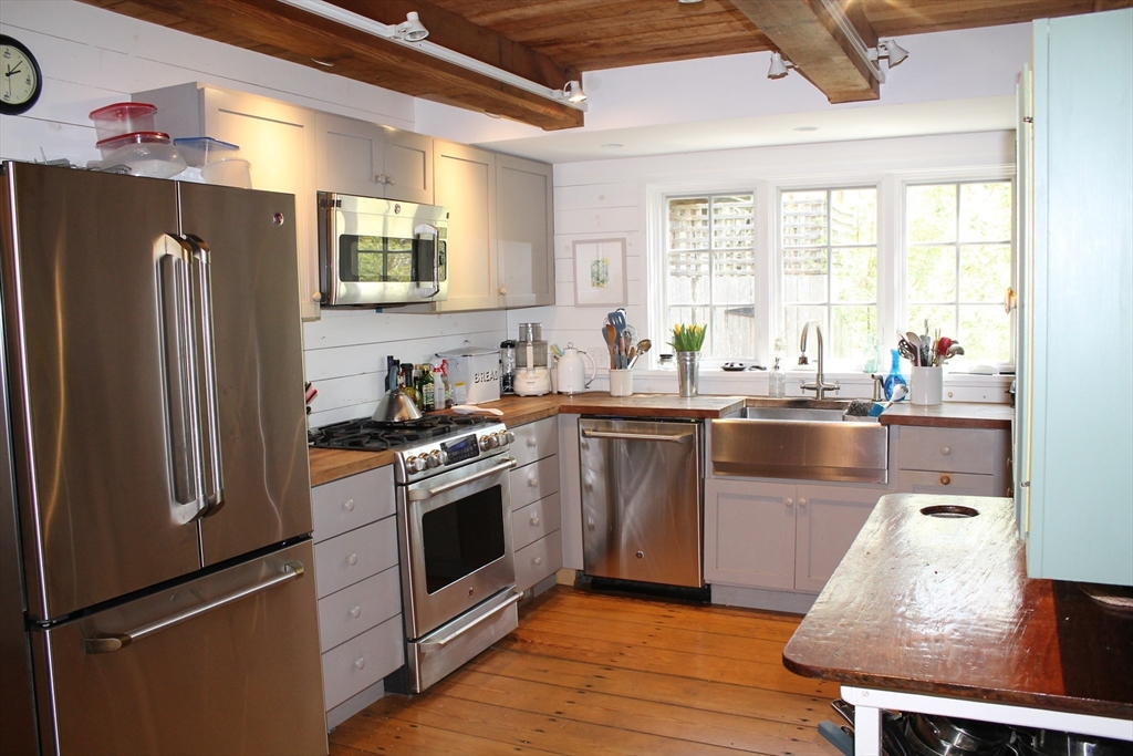 225 Lamberts Cove Road West Tisbury, MA 02568 - Photo 8 of 33 a kitchen with granite countertop a sink stainless steel appliances and cabinets