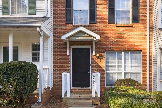 a view of a house with a tree in the background