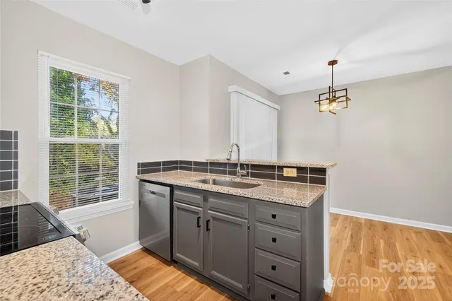 a bathroom with a granite countertop sink a vanity and a large mirror