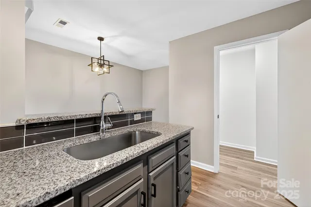 a kitchen with a sink and cabinets