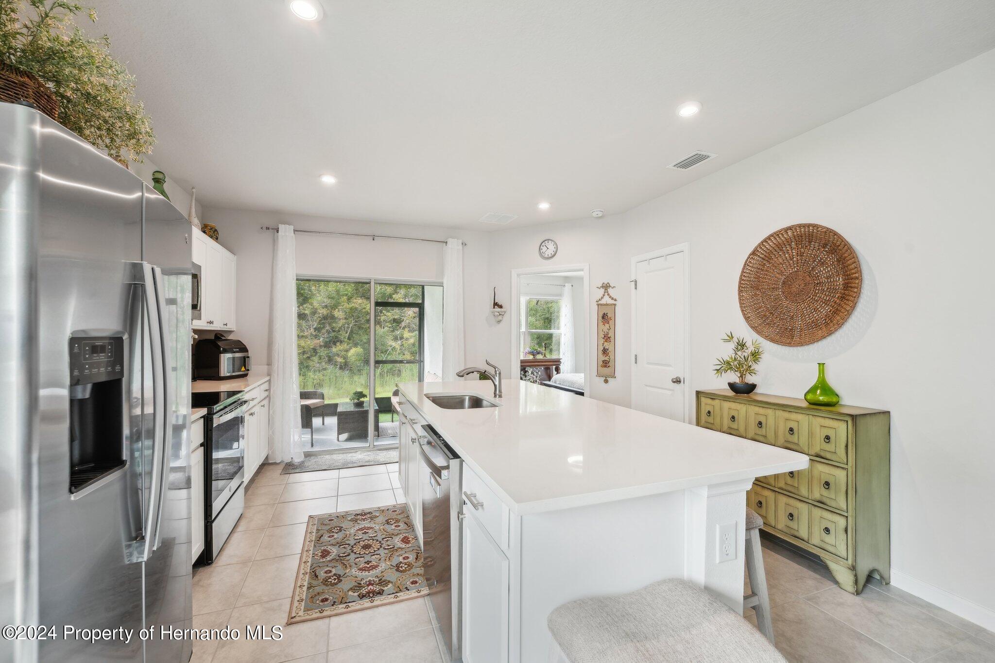 12214 Grizzly Lane New Port Richey, FL 34654 - Photo 15 of 49 a large kitchen with a table and chairs
