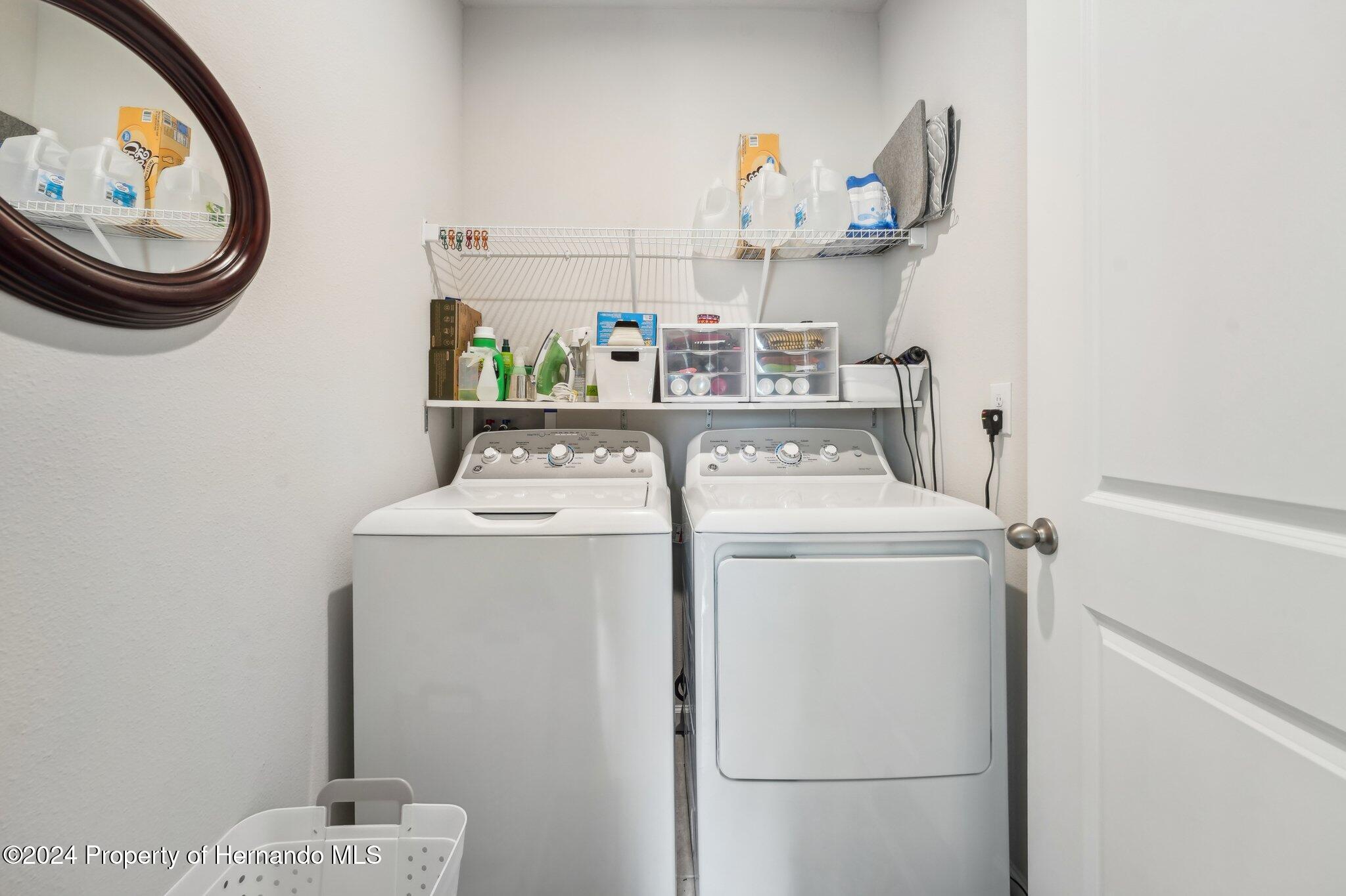 12214 Grizzly Lane New Port Richey, FL 34654 - Photo 22 of 49 a utility room with dryer and washer