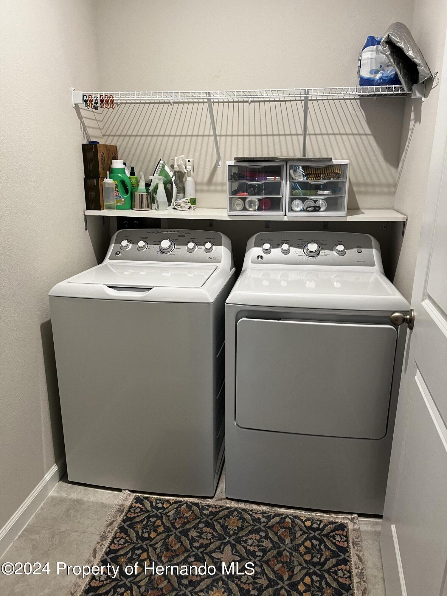 12214 Grizzly Lane New Port Richey, FL 34654 - Photo 23 of 49 a utility room with dryer and washer