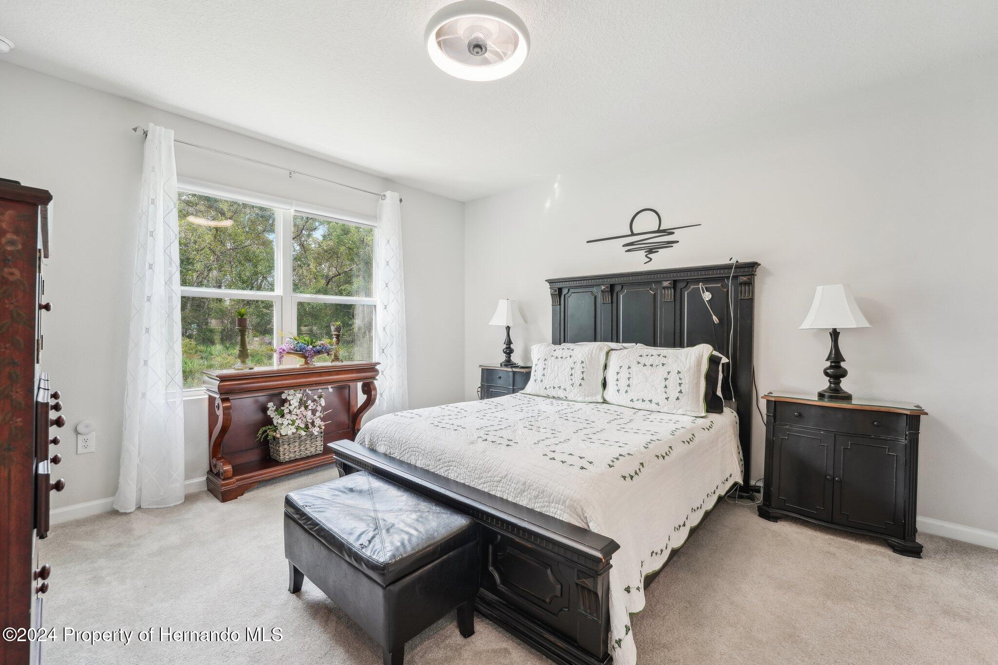 12214 Grizzly Lane New Port Richey, FL 34654 - Photo 24 of 49 a bedroom with a bed and a window