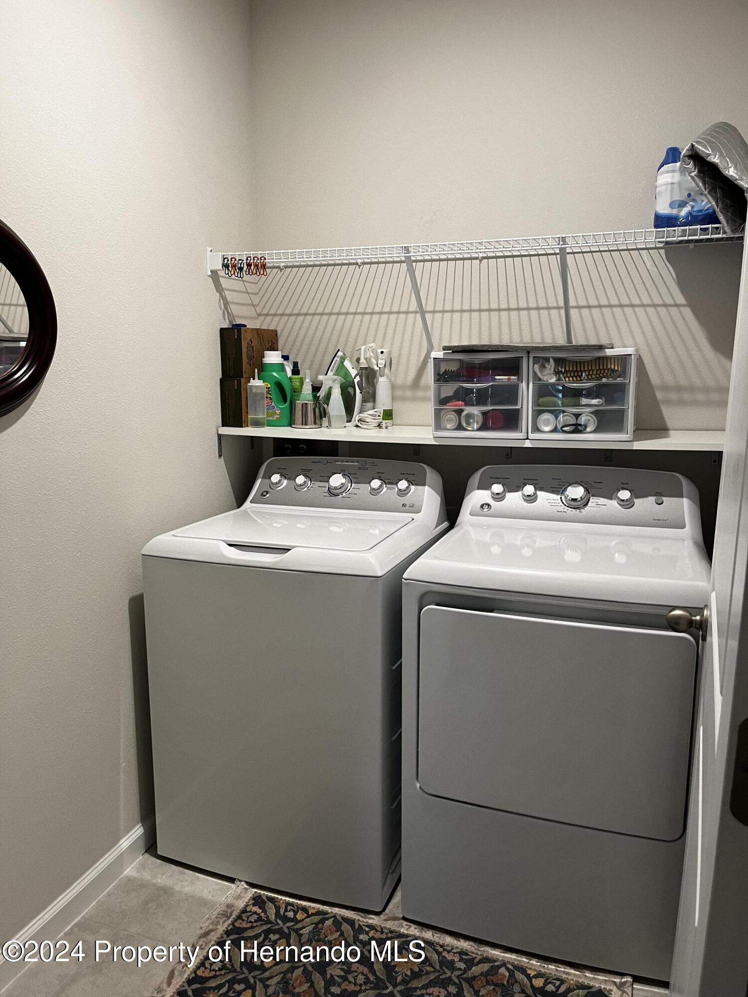 12214 Grizzly Lane New Port Richey, FL 34654 - Photo 25 of 49 a utility room with dryer and washer