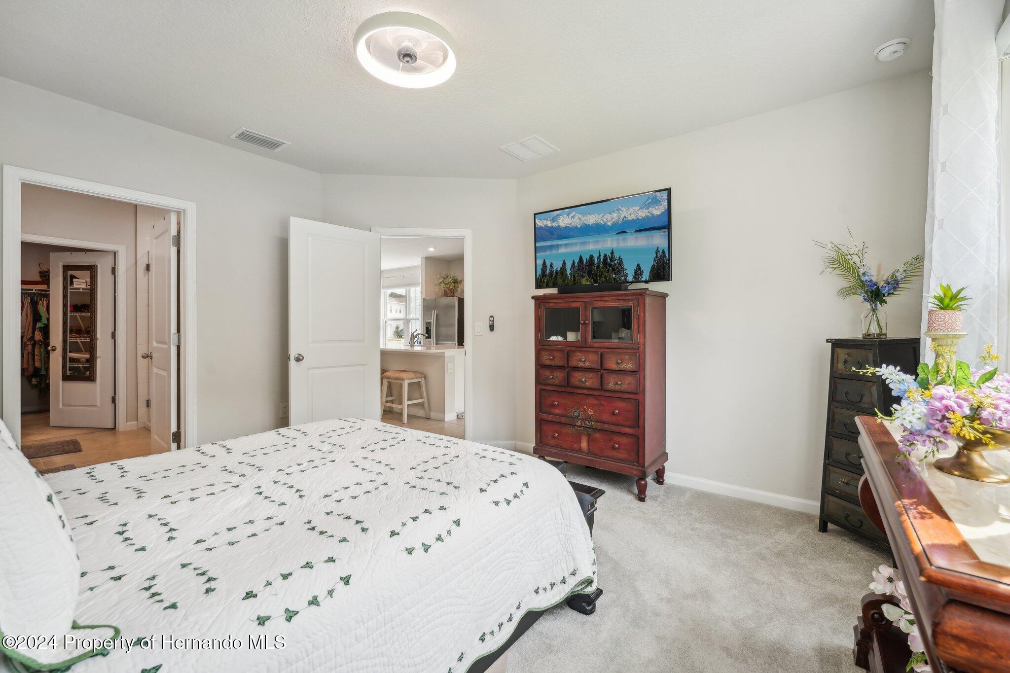 12214 Grizzly Lane New Port Richey, FL 34654 - Photo 26 of 49 a bedroom with a bed and a dresser