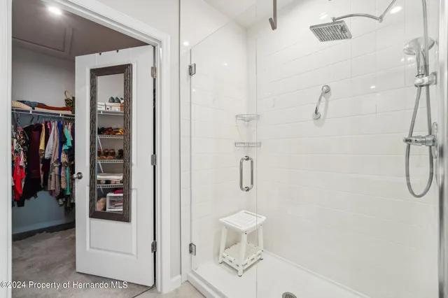 a walk in closet and shower in a bathroom