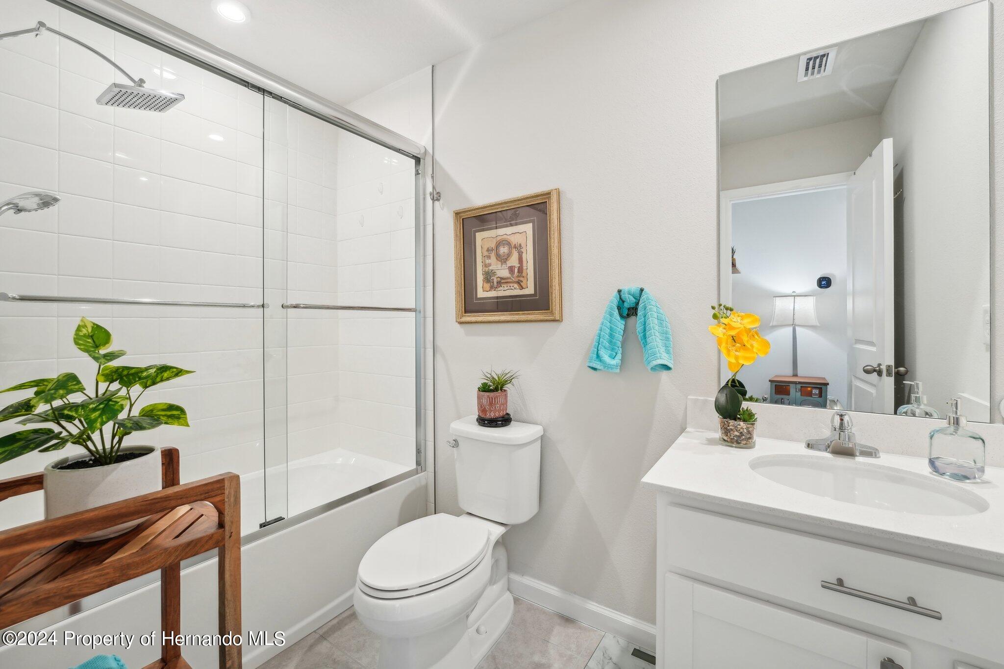 12214 Grizzly Lane New Port Richey, FL 34654 - Photo 35 of 49 a bathroom with a sink toilet and a mirror