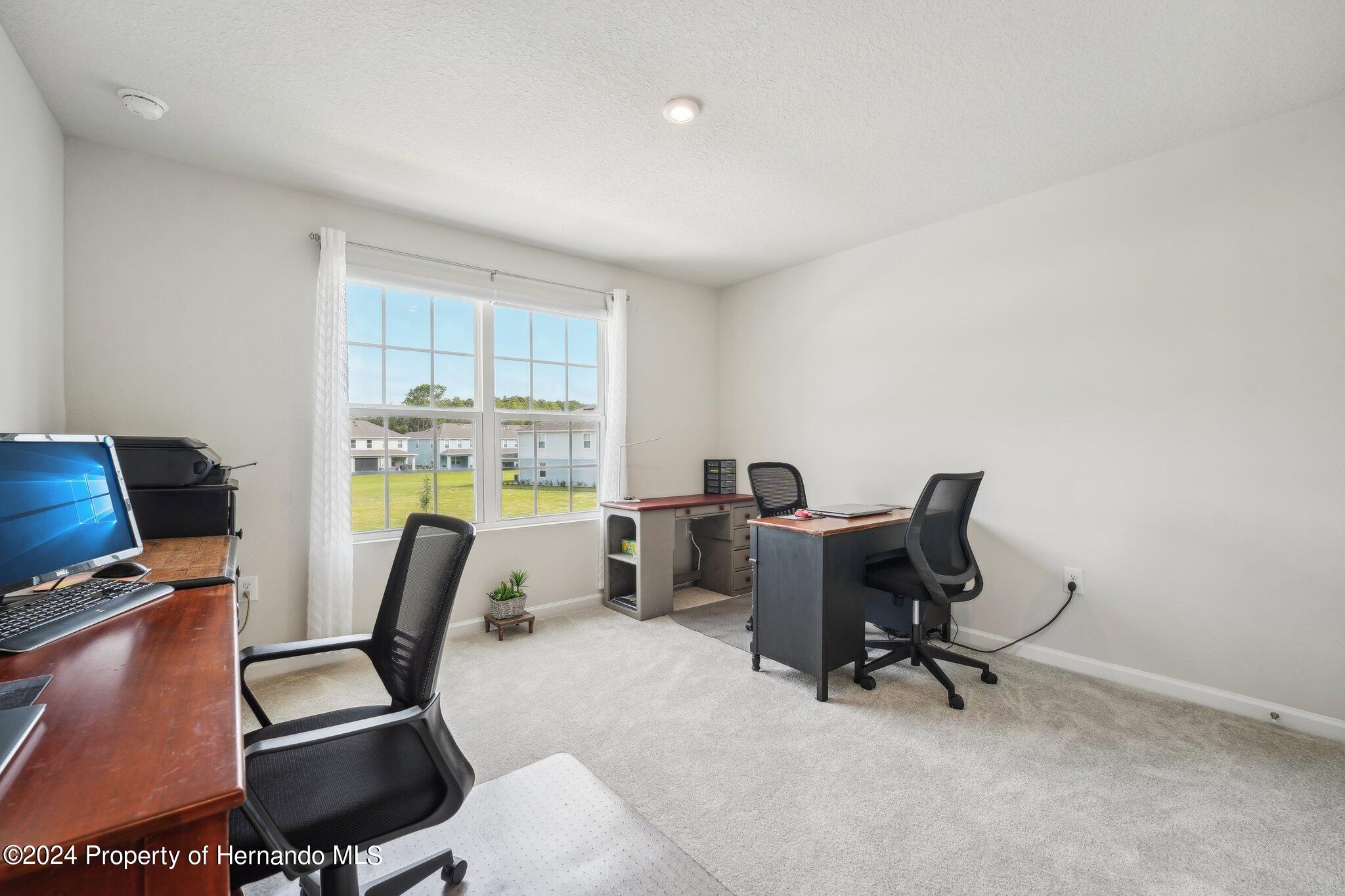 12214 Grizzly Lane New Port Richey, FL 34654 - Photo 36 of 49 a view of a workspace with furniture and a window