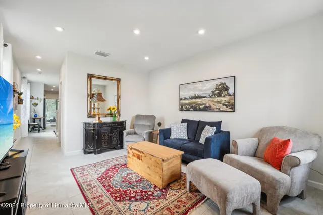 a living room with furniture and a rug