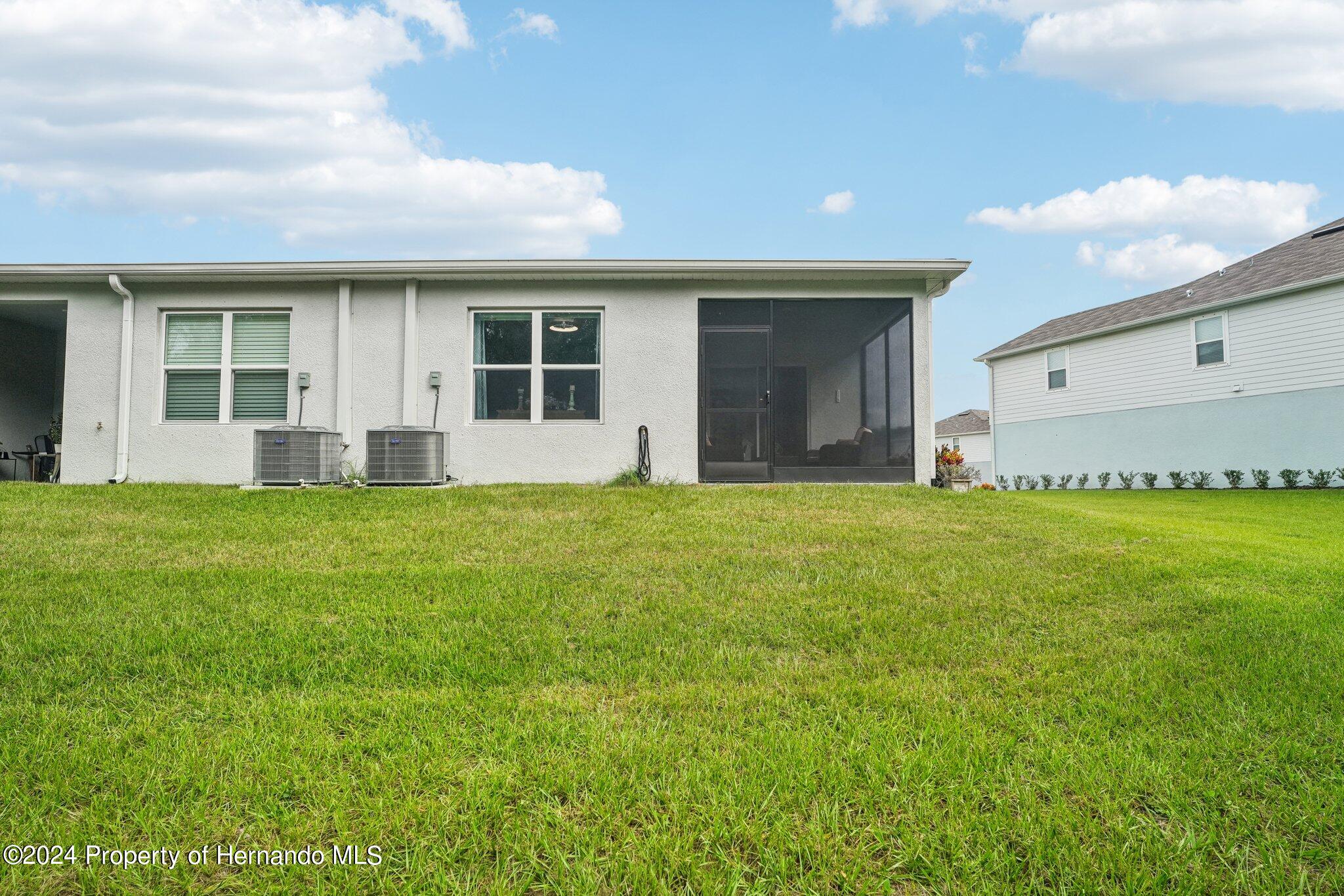 12214 Grizzly Lane New Port Richey, FL 34654 - Photo 47 of 49 a front view of house with yard and green space