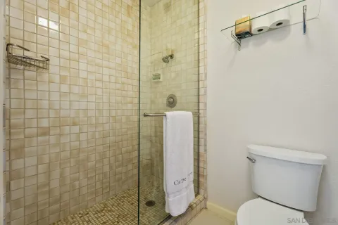 a bedroom with two beds and painting on the wall