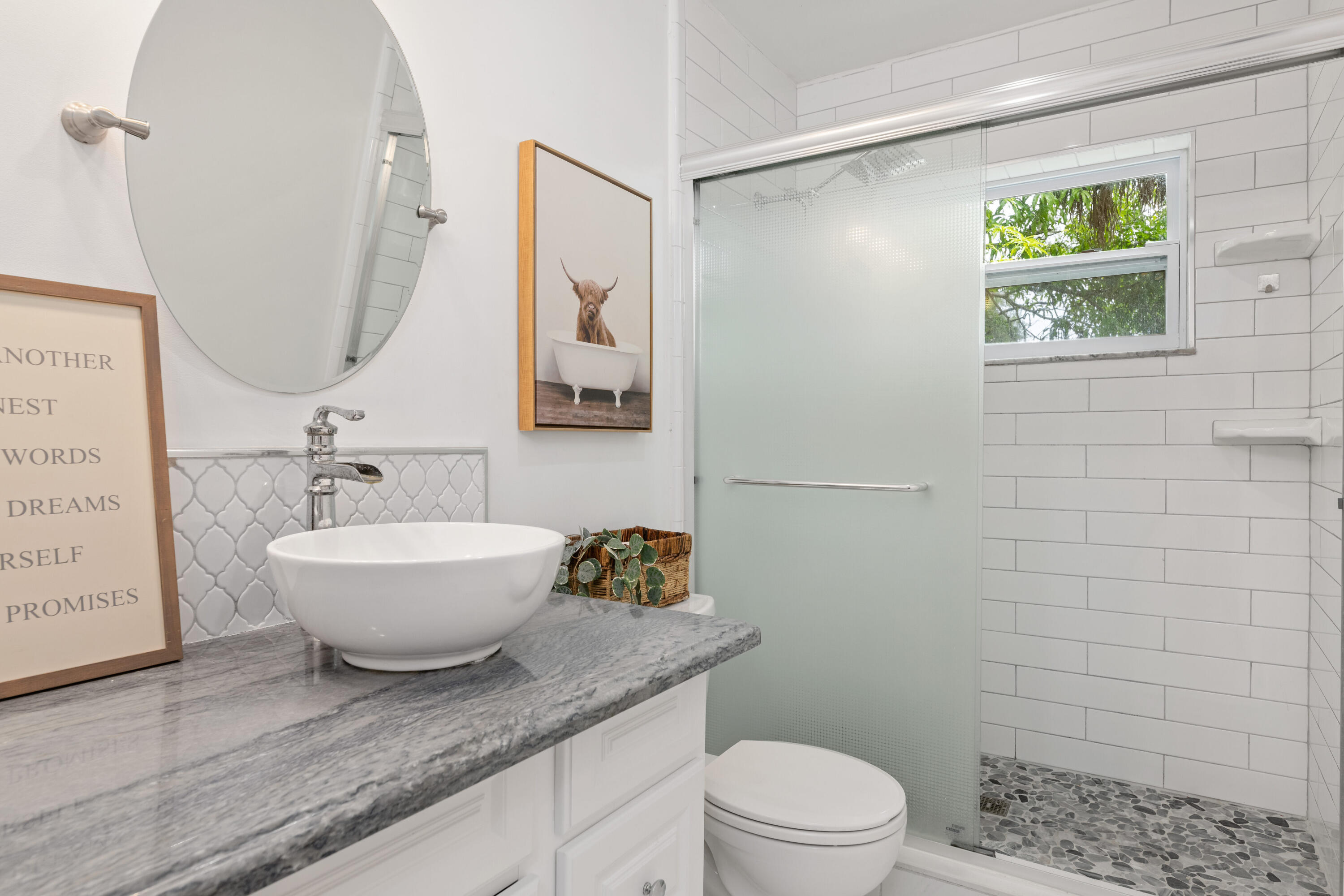 4534 County Line Road Tequesta, FL 33469 - Photo 12 of 26 a bathroom with a granite countertop sink toilet a mirror and shower