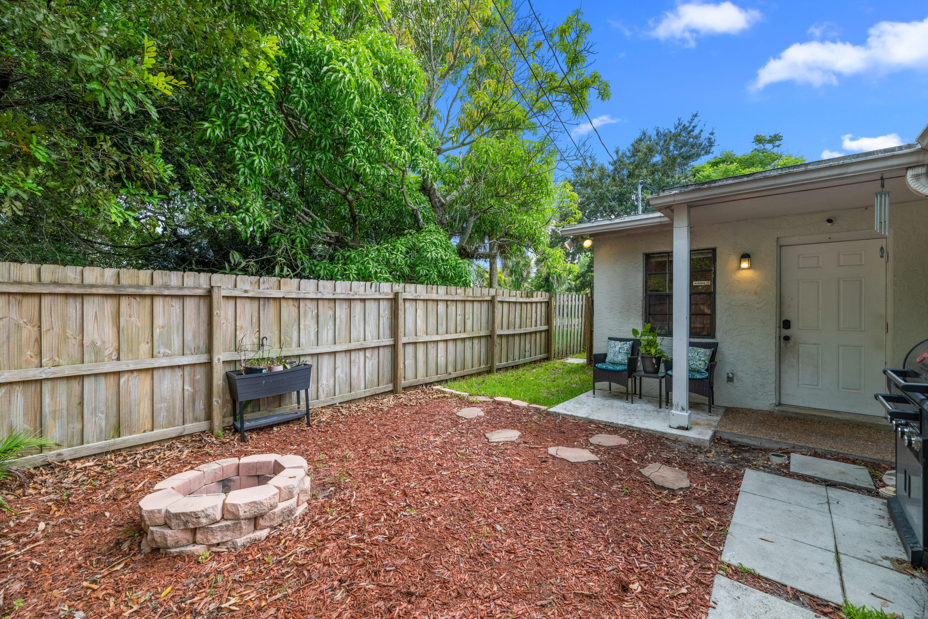 4534 County Line Road Tequesta, FL 33469 - Photo 21 of 26 a view of a backyard with a patio