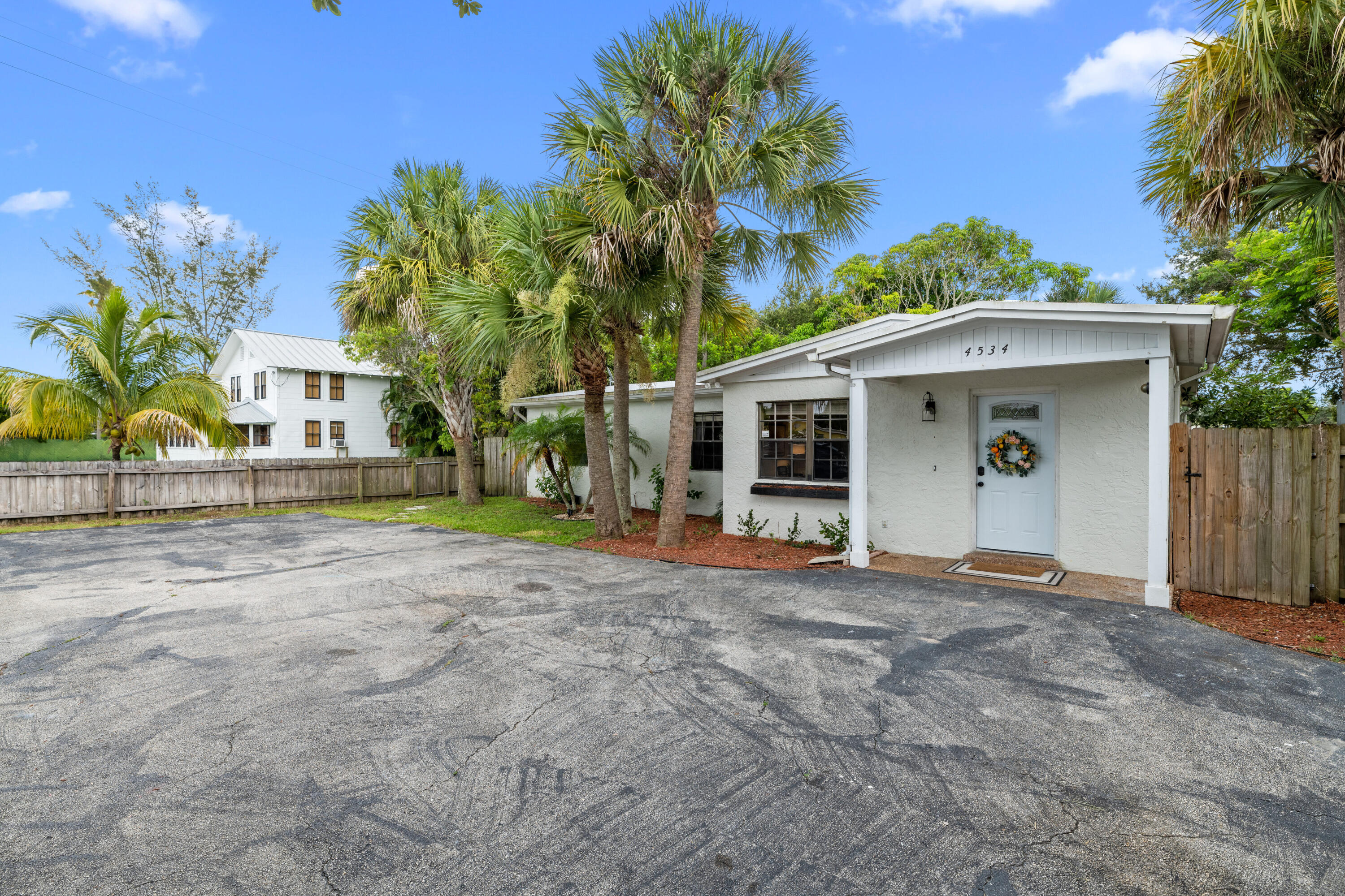 4534 County Line Road Tequesta, FL 33469 - Photo 23 of 26 a view of a house with a garage