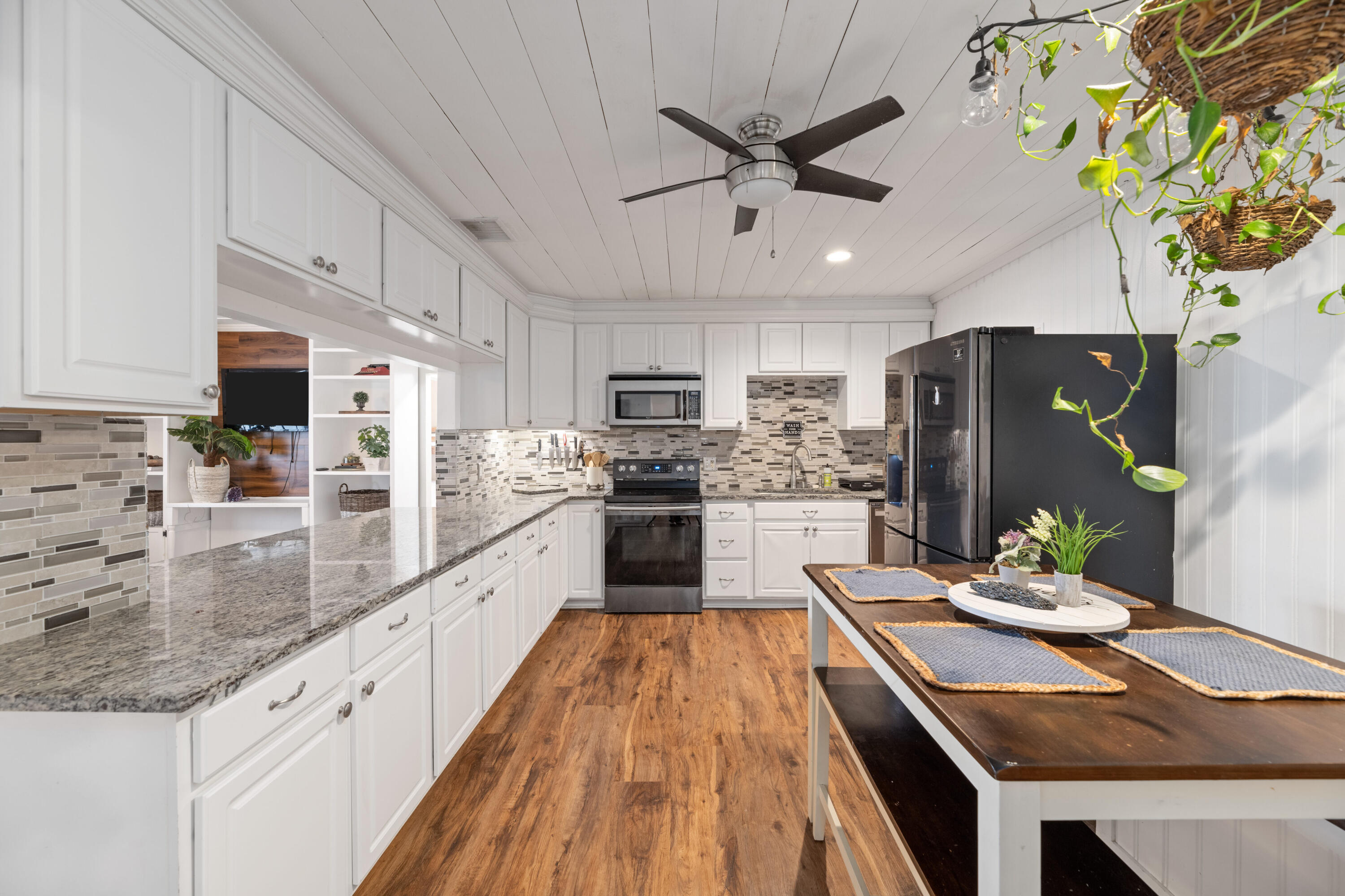 4534 County Line Road Tequesta, FL 33469 - Photo 4 of 26 a large kitchen with stainless steel appliances kitchen island granite countertop a refrigerator a stove a sink and dishwasher