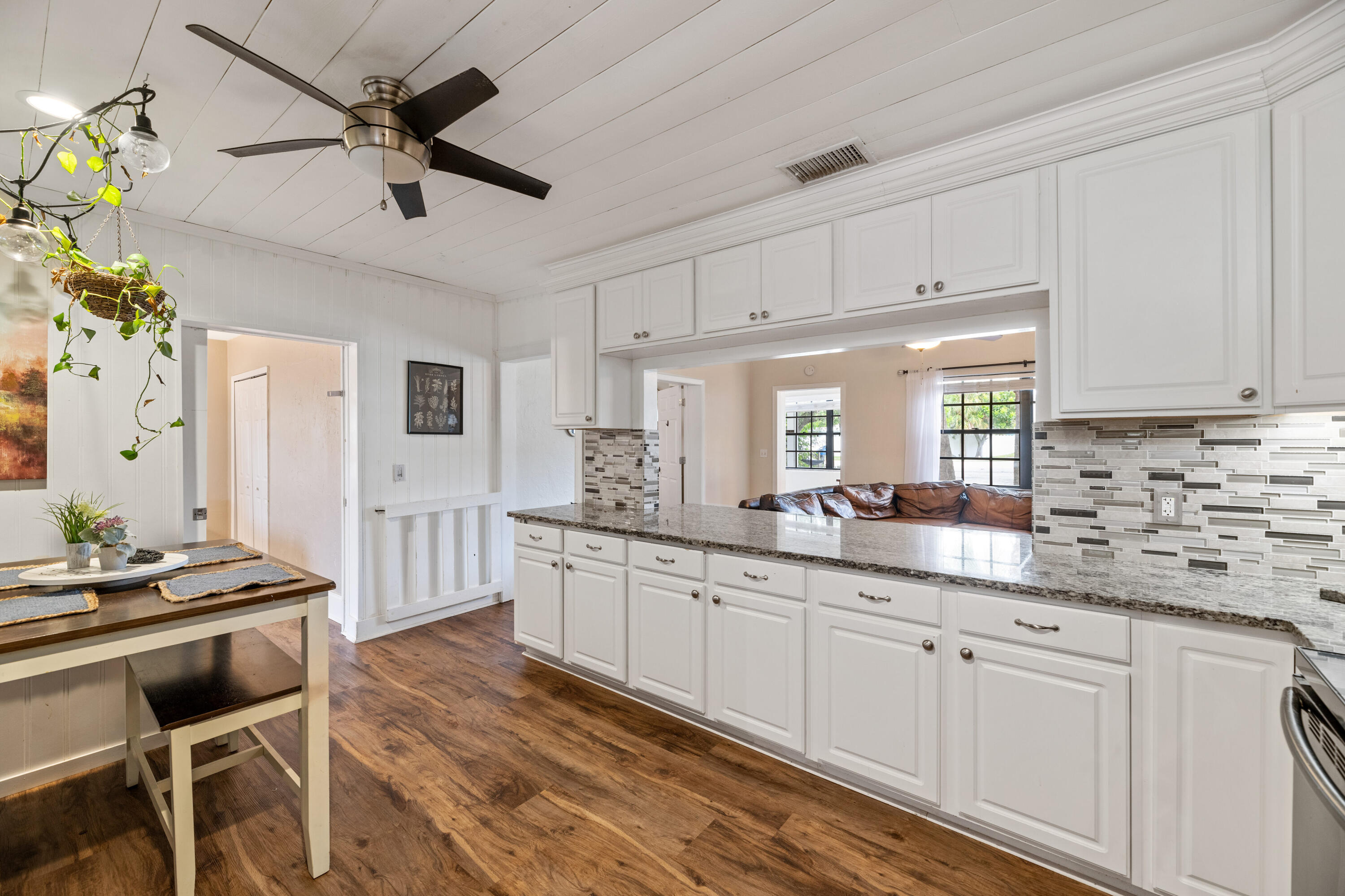 4534 County Line Road Tequesta, FL 33469 - Photo 6 of 26 a kitchen with granite countertop a sink cabinets and window