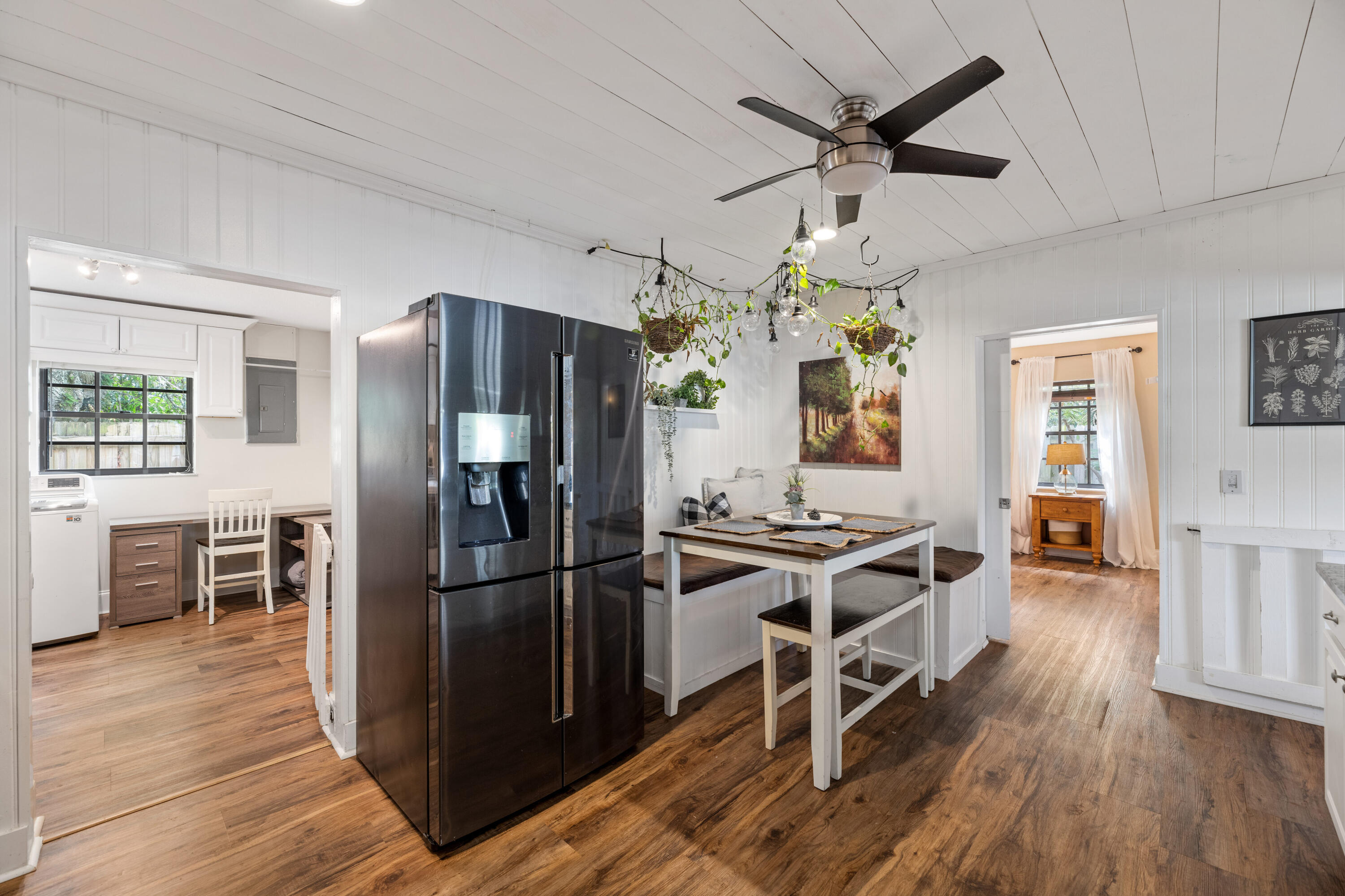 4534 County Line Road Tequesta, FL 33469 - Photo 7 of 26 a kitchen with stainless steel appliances a stove refrigerator sink and wooden floor